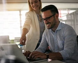 A man and a woman with a laptop